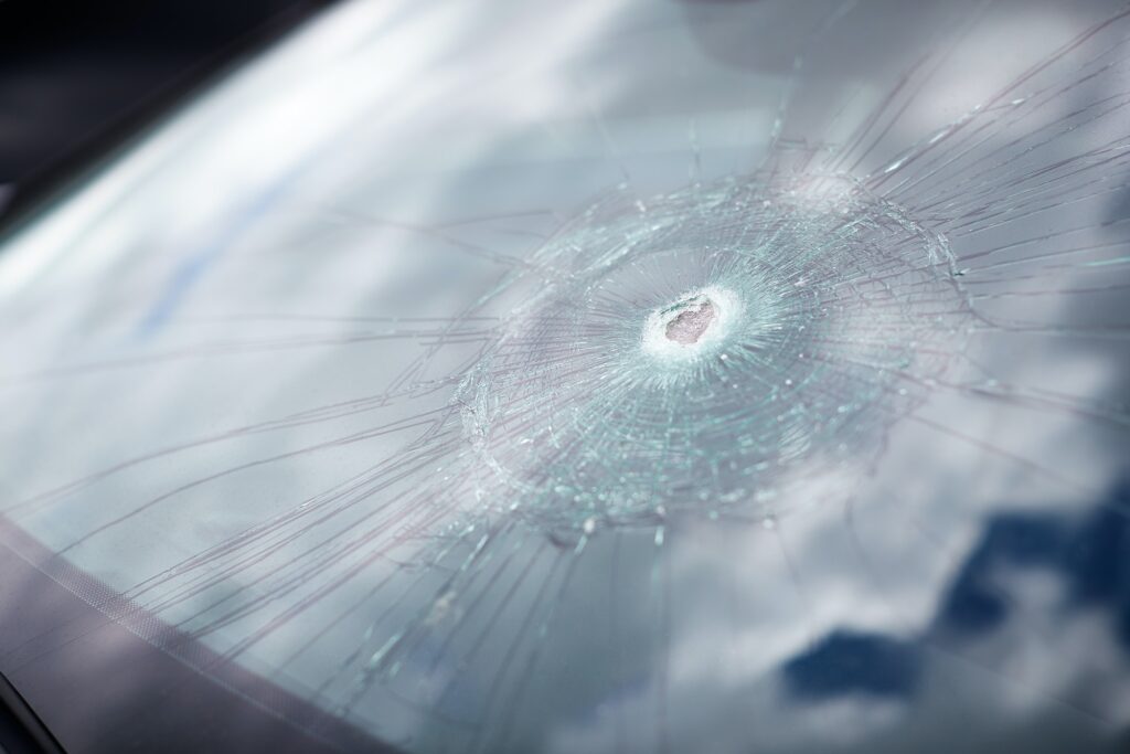 Detail Of Damage To Windscreen Of Car Shattered By Vandalism
